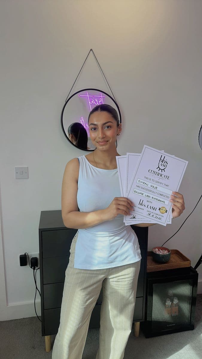 A graduate holding her BB's Lash certificate